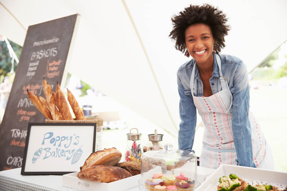 A woman at her booth at the Princeville market.