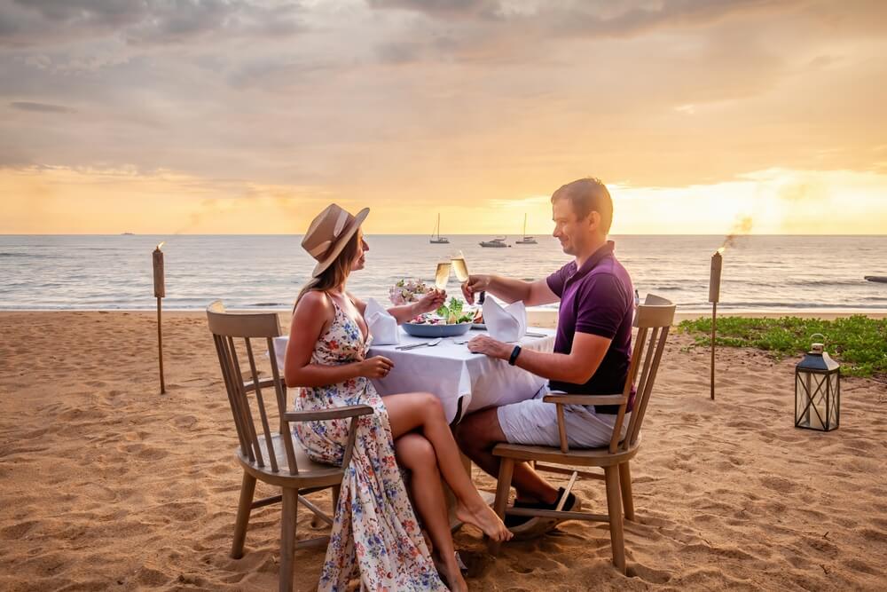 A couple eating at one of the top beachfront restaurants on Kauai.