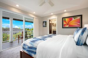 The bedroom of a Kauai vacation rental to relax in after hiking to nearby waterfalls.